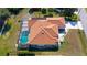 Aerial view of single-Gathering home with pool and fenced backyard at 108 Mccabe St, Port Charlotte, FL 33953