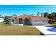 Single-story home with tile roof, fountain, and two-car garage at 108 Mccabe St, Port Charlotte, FL 33953