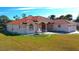 Single-story home with tile roof, fountain, and two-car garage at 108 Mccabe St, Port Charlotte, FL 33953