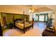 Large main bedroom with a four-poster bed and large windows at 108 Mccabe St, Port Charlotte, FL 33953