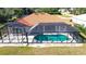 Screened pool and patio area with lush green landscaping at 108 Mccabe St, Port Charlotte, FL 33953