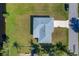 Aerial view of a single-Gathering home with a large backyard and driveway at 102 Annapolis Ln, Rotonda West, FL 33947