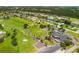 Aerial view of a golf course community with houses and waterways at 102 Annapolis Ln, Rotonda West, FL 33947