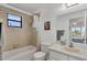 Bathroom with tub shower combination and neutral tile at 102 Annapolis Ln, Rotonda West, FL 33947