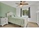 Bright bedroom with light wood double bed frame and light green bedding at 102 Annapolis Ln, Rotonda West, FL 33947