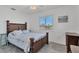 Bedroom with dark wood platform bed and light blue bedding at 102 Annapolis Ln, Rotonda West, FL 33947