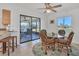 Dining area with glass table, wicker chairs, and access to a screened porch at 102 Annapolis Ln, Rotonda West, FL 33947