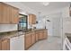 Kitchen with light wood cabinets, green granite counters, and white appliances at 102 Annapolis Ln, Rotonda West, FL 33947