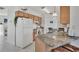 Kitchen with light wood cabinets, green granite counters, and breakfast bar at 102 Annapolis Ln, Rotonda West, FL 33947