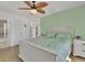 Main bedroom with a white bed frame, light green bedding, and ceiling fan at 102 Annapolis Ln, Rotonda West, FL 33947