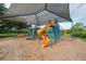 playground with a spiral slide under a shade structure at 102 Annapolis Ln, Rotonda West, FL 33947