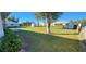 Large backyard with grassy area and neighboring homes visible at 10454 Waterford Ave, Englewood, FL 34224