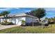 View of the home's side, showcasing the garage and fenced yard at 10454 Waterford Ave, Englewood, FL 34224