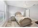 Cozy bedroom with a queen-size bed and a tiled floor at 10628 Nicklaus Ct, Englewood, FL 34223