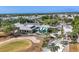 Aerial view of community clubhouse with patio and golf course at 10628 Nicklaus Ct, Englewood, FL 34223