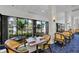 Clubhouse dining area with tables and chairs, offering views of the outdoors at 10628 Nicklaus Ct, Englewood, FL 34223