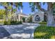 Community clubhouse entrance with palm trees and landscaped grounds at 10628 Nicklaus Ct, Englewood, FL 34223