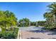 Gated community entrance with palm trees at 10628 Nicklaus Ct, Englewood, FL 34223