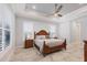 Relaxing main bedroom with a king-size bed, large windows, and wood flooring at 10628 Nicklaus Ct, Englewood, FL 34223