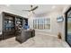 Home office with built-in shelving and pool view at 10628 Nicklaus Ct, Englewood, FL 34223