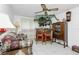 Small bar area with red counter, wooden stools and display cabinet at 115 Sw Seville Sw Pl, Port Charlotte, FL 33952