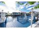 Relaxing waterfront dock with white chairs at 115 Sw Seville Sw Pl, Port Charlotte, FL 33952