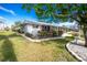 Single story home with manicured lawn and waterfront view at 115 Sw Seville Sw Pl, Port Charlotte, FL 33952