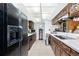 View of kitchen with stained glass cabinets and black appliances at 115 Sw Seville Sw Pl, Port Charlotte, FL 33952