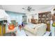 Bright living room features tiled floors and a formal dining area at 115 Sw Seville Sw Pl, Port Charlotte, FL 33952