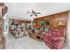 Living room with wood-paneled walls and comfortable seating at 115 Sw Seville Sw Pl, Port Charlotte, FL 33952