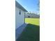 Newly built home with grassy backyard and paved patio at 12547 Trinity Ave, Port Charlotte, FL 33953