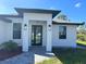 Modern front entrance with black double doors and stone walkway at 12547 Trinity Ave, Port Charlotte, FL 33953