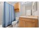 Simple bathroom with shower/tub combo, toilet and wood cabinets at 1259 Jonah Dr, North Port, FL 34289