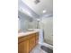 Clean bathroom with shower, vanity, and wood cabinets at 1259 Jonah Dr, North Port, FL 34289