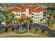 Aerial view of a luxury condo building with palm trees and waterfront access at 1340 Rock Dove Ct # 134, Punta Gorda, FL 33950