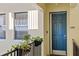 Private condo entrance with teal door and potted plants at 1340 Rock Dove Ct # 134, Punta Gorda, FL 33950