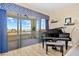 Bright room with grand piano and access to balcony overlooking water at 1340 Rock Dove Ct # 134, Punta Gorda, FL 33950