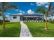 Home exterior showcasing a paved walkway to the backyard and covered patio at 1380 Willet Ct, Punta Gorda, FL 33950