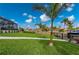 Spacious backyard with a paved walkway, lush lawn, and canal view at 1380 Willet Ct, Punta Gorda, FL 33950