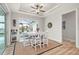 Bright dining area with white table and chairs, and access to a screened porch at 1380 Willet Ct, Punta Gorda, FL 33950