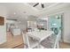 Kitchen and dining area with white cabinets, a large island, and breakfast bar at 1380 Willet Ct, Punta Gorda, FL 33950