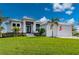 Beautiful two-story home with a metal roof, lush landscaping, and driveway at 1380 Willet Ct, Punta Gorda, FL 33950