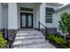 Elegant entryway with double doors and stone accents at 1380 Willet Ct, Punta Gorda, FL 33950