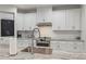 Sleek kitchen with white cabinetry, granite countertops, and a farmhouse sink at 1380 Willet Ct, Punta Gorda, FL 33950