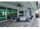 Covered lanai with comfortable seating and a TV at 1380 Willet Ct, Punta Gorda, FL 33950