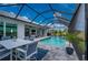 Spacious pool area with dining furniture and a covered lanai at 1380 Willet Ct, Punta Gorda, FL 33950