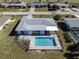 This is an aerial view of the home with a backyard pool in a residential neighborhood at 143 Rotonda Cir, Rotonda West, FL 33947