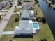 Aerial view of home with pool and canal at 143 Rotonda Cir, Rotonda West, FL 33947