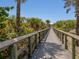 Wooden boardwalk leading to beach access at 143 Rotonda Cir, Rotonda West, FL 33947