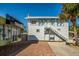 Two-story white building with white stairs and green trim at 143 Rotonda Cir, Rotonda West, FL 33947